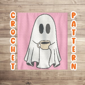 May include: A white ghost holding a coffee cup, with the word "CROCHET" on the left and "PATTERN" on the right. The ghost is on a pink background, and the image is set against a wooden backdrop.