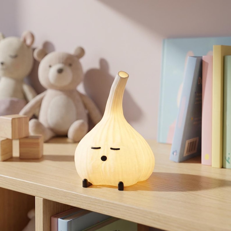 Yellow glowing garlic lamp on a shelf with books, blocks, and stuffed bears