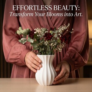 Woman in a rose-colored dress holding a white matte textured fluted flower vase filled with burgundy and green stems, with the text "EFFORTLESS BEAUTY: Transform Your Blooms into Art."