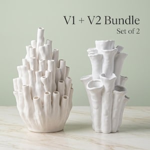 Two matte white textured coral vases side by side under a "V1 + V2 Bundle, Set of 2" label. Sculptural vase pair with branching openings, each about 7.2 in tall.