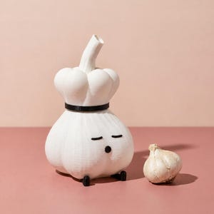 Unlit white garlic lamp wearing a black-banded chef hat on a pink background