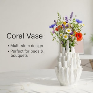 Product graphic reading "Coral Vase" beside a matte white textured vase holding colorful wildflowers, with small caption text below the title.