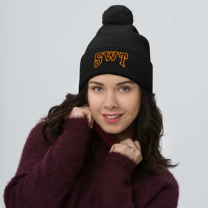 May include: Black knit beanie with a pom pom on top and the letters "SWT" embroidered in gold and maroon.