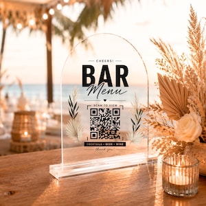 May include: An arched clear acrylic sign featuring black text that reads BAR MENU, CHEERS!, SCAN TO VIEW, COCKTAILS BEER WINE, and thank you. The sign includes a central QR code and decorative botanical illustrations of dried palm leaves and foliage.
