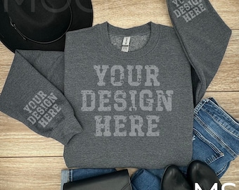 Puede incluir: Una sudadera gris jaspeada de manga larga y cuello redondo. La sudadera tiene el texto "YOUR DESIGN HERE" impreso en la parte delantera y las mangas.