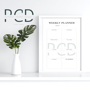 May include: A white framed weekly planner with the text "WEEKLY PLANNER" and "WEEK OF" at the top. The planner is divided into seven sections for each day of the week, with the days of the week labeled at the top of each section. The planner also includes a section for "TOP PRIORITIES".