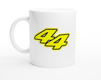 May include: White ceramic mug with a yellow number "44" printed on it. The number is outlined in black.
