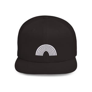 May include: A black baseball cap with a flat brim. The cap features a white embroidered rainbow design on the front. The rainbow is composed of several curved lines, creating a simple, yet eye-catching graphic.