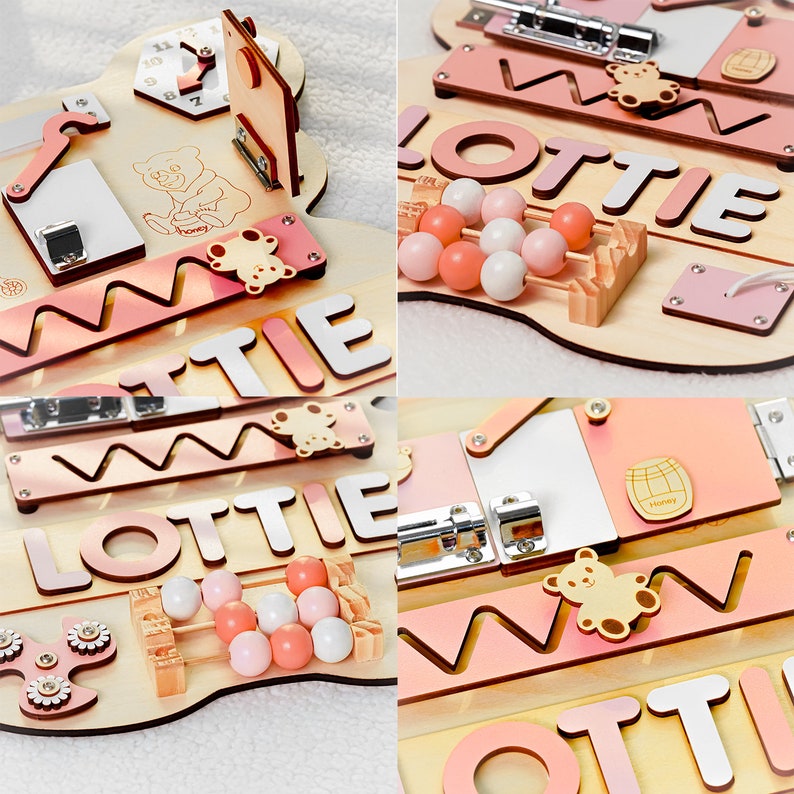 May include: A wooden activity board for children with a pink and white color scheme. The board features a variety of activities, including a clock, a bead maze, a shape sorter, a zipper, a latch, and a mirror. The board is personalized with the name "Lottie".