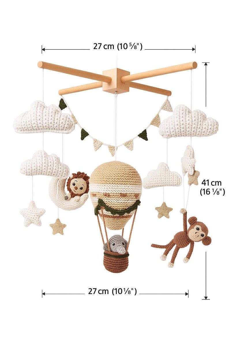 May include: A handcrafted baby mobile featuring a wooden frame, measuring 27 cm (10 5/8") wide and 41 cm (16 1/8") tall. It includes crocheted clouds, stars, a lion on a crescent moon, a hot air balloon with an animal, and a monkey.