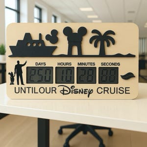 May include: A wooden Disney cruise countdown clock with black silhouette designs of a ship, Mickey Mouse, and a palm tree. The clock displays the time remaining until the cruise, with the text "UNTIL OUR Disney CRUISE".