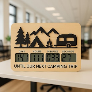 May include: A wooden camping countdown clock with a black mountain, tent, campfire, and camper design. The digital display shows 141 days, 111 hours, 33 minutes, and 27 seconds until the next camping trip.