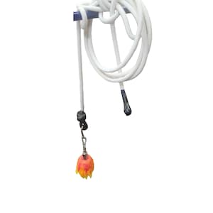 May include: White rope with a decorative pull featuring a flame-shaped charm with red, orange, and yellow hues. The rope is looped and knotted around a blue rod, with a black pull at the end.
