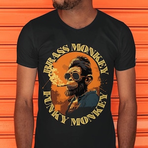 May include: A black t-shirt with a circular graphic of a monkey wearing sunglasses and smoking a cigarette. The graphic has the text "Brass Monkey Funky Monkey" around it.