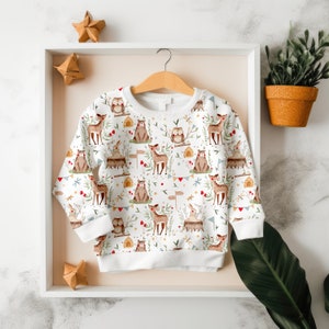May include: White baby onesie with a woodland animal print featuring deer, owls, and bunnies. The onesie has a white background with a repeating pattern of the animals and foliage.