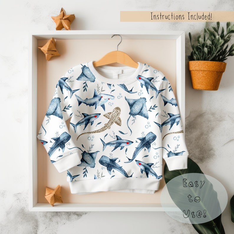 May include: White sweatshirt with a blue and white pattern of sharks, rays, and other sea creatures. The text "Easy to Use!" is visible in the lower right corner of the image.