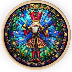 May include: A round wooden wall clock with a stained glass design featuring a Nutcracker holding a drum stick. The stained glass design is in shades of blue, green, red, and gold. The clock face is black with white numbers.