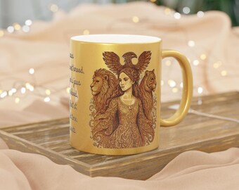 May include: Gold-coloured ceramic mug with a detailed illustration of a woman flanked by a lion and tiger, and an eagle above. The mug has a gold handle and interior. The design is in shades of brown and gold, with a gold finish.