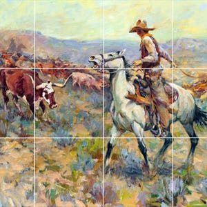 May include: A cowboy on a white horse rides through a herd of cattle. The cowboy is wearing a brown hat and a light blue shirt. The cattle are brown and white and are scattered across a grassy field.