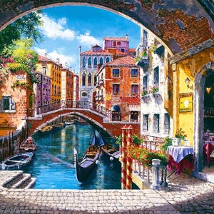 May include: A painting of a canal in Venice, Italy. The canal is lined with colorful buildings and a bridge crosses the water. There are gondolas in the water and a cafe on the right side of the image.