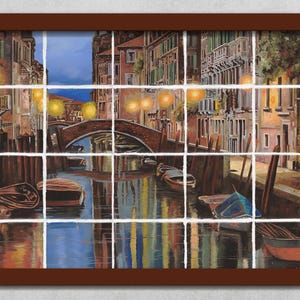 May include: A painting of a canal in Venice, Italy. The canal is lined with buildings and there are boats in the water. The scene is lit by streetlights and the sky is a soft blue.