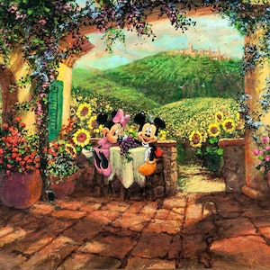May include: Mickey Mouse and Minnie Mouse are sitting at a table on a patio with a view of a green hillside and a town in the distance. They are enjoying a meal with a glass of wine. The patio is surrounded by flowers and vines.