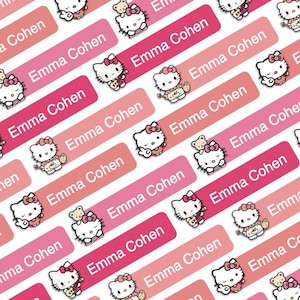 May include: Pink and red rectangular labels with a Hello Kitty character design. The labels have the name "Emma Cohen" printed on them.