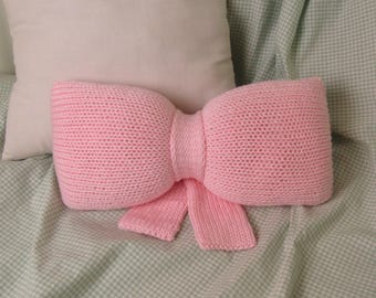 Knitted Bow Pillow: Handmade Accent Pillow for Girl's Nursery