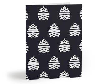 May include: A folded greeting card featuring a repeating pattern of white, stylized pinecone shapes arranged in a grid against a solid dark charcoal background. The design consists of horizontal, layered segments that form the pointed, oval-like silhouettes.