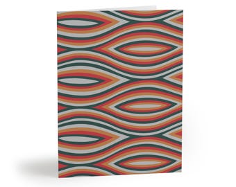 May include: A folded greeting card featuring a repeating pattern of horizontal, elongated, eye-shaped curves. The design consists of layered bands in shades of dark forest green, muted orange, bright red, and light gray, creating a rhythmic wave effect.