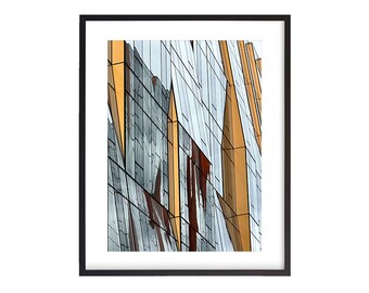 May include: Abstract photograph of a building with a geometric pattern of gold and silver glass panels.