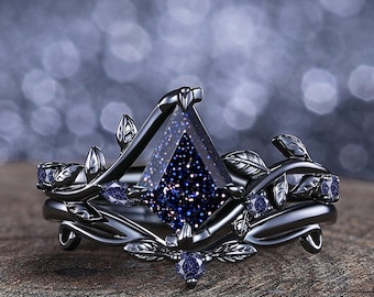 May include: A black ring set with a large, dark blue, square-shaped gemstone surrounded by smaller, dark blue gemstones. The ring band is decorated with a vine design.
