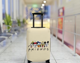 May include: A beige suitcase featuring a print of Mickey Mouse and his friends. The suitcase has the word "FRIENDS" printed on the front.
