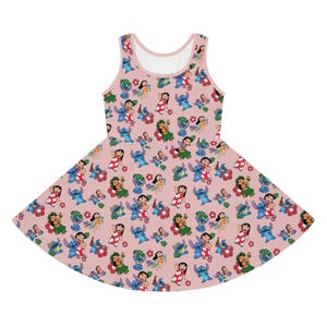 May include: A pink sleeveless dress featuring a repeating pattern of Stitch and Lilo characters from the Disney film Lilo & Stitch. The characters are wearing Hawaiian clothing and are surrounded by flowers and leaves.