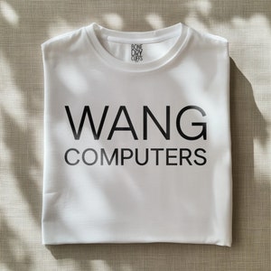 May include: White t-shirt with black text that reads "WANG COMPUTERS" and a small label that reads "BONE DRY CUFFS".