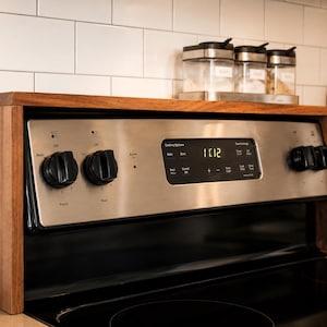 Hardwood stove shelf organizer in walnut style finish made for kitchen counter storage and spice organization with customizable length and height to fit your stove and help keep bottles jars and seasoning containers neatly arranged
