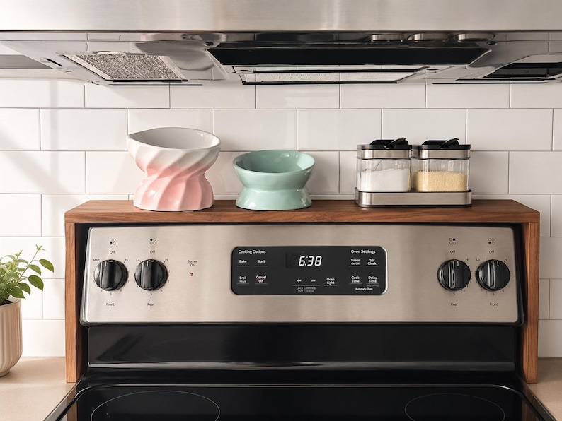 Handmade walnut stove top organizer shelf with adjustable size for different stove lengths and back panel heights ideal for creating extra kitchen storage and displaying spices oils jars and cooking supplies in a clean stylish way
