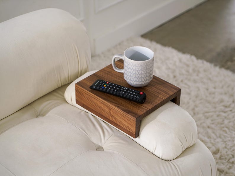 White oak sofa side table designed to rest securely on the arm of a couch or sofa provides a stable surface for holding drinks snacks remotes or phones this wood armrest tray table also functions as a compact side table ideal for small living rooms apartments and minimalist spaces