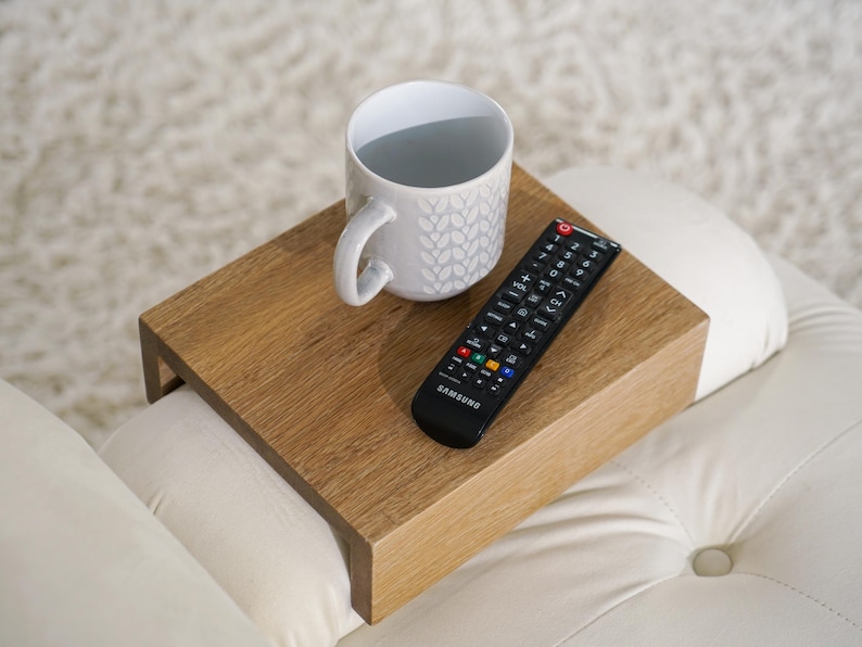 Wood couch side table in natural white oak designed as a sofa arm tray or armrest table perfect for compact spaces and modern living rooms this table fits securely on your couch arm providing a stable surface for coffee books remotes or snacks great for enhancing comfort and function in tight spaces