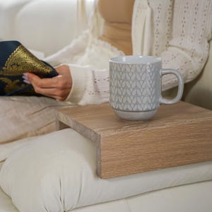 White oak couch arm tray table handcrafted for functionality and style serves as a sofa armrest table or wood side table designed for small spaces it provides a stable surface for drinks or snacks fits securely on most sofa arms and enhances the look of any modern or rustic interior