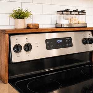 Hardwood stove shelf organizer in walnut style finish made for kitchen counter storage and spice organization with customizable length and height to fit your stove and help keep bottles jars and seasoning containers neatly arranged