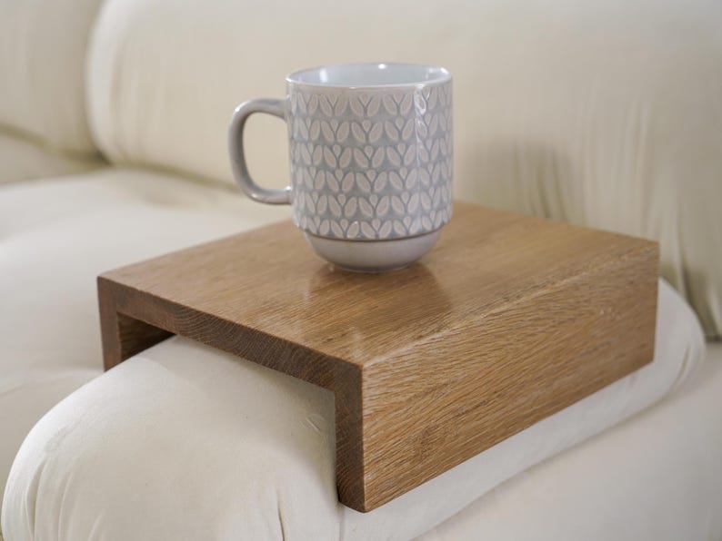 Sofa arm tray table made from solid white oak fits over the arm of your couch to create a convenient and sturdy surface for daily use perfect for holding snacks coffee remotes or a phone this wood couch side table adds function and style to compact living spaces with a clean natural finish