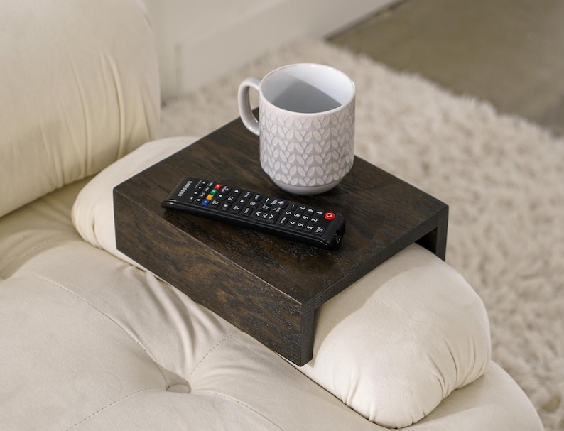 Sofa arm tray table made from solid white oak fits over the arm of your couch to create a convenient and sturdy surface for daily use perfect for holding snacks coffee remotes or a phone this wood couch side table adds function and style to compact living spaces with a clean natural finish