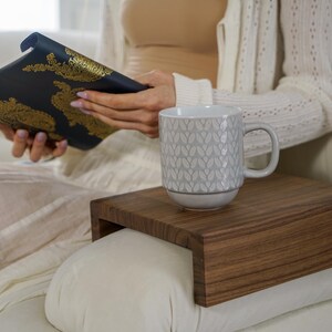 White oak sofa side table designed to rest securely on the arm of a couch or sofa provides a stable surface for holding drinks snacks remotes or phones this wood armrest tray table also functions as a compact side table ideal for small living rooms apartments and minimalist spaces