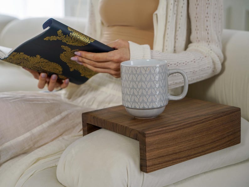 White oak sofa side table designed to rest securely on the arm of a couch or sofa provides a stable surface for holding drinks snacks remotes or phones this wood armrest tray table also functions as a compact side table ideal for small living rooms apartments and minimalist spaces