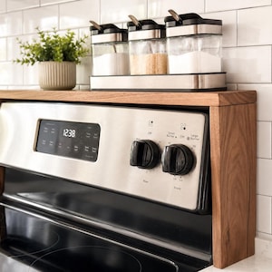 Handmade walnut stove top organizer shelf with adjustable size for different stove lengths and back panel heights ideal for creating extra kitchen storage and displaying spices oils jars and cooking supplies in a clean stylish way
