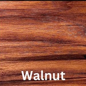 May include: A close-up view of a smooth, polished walnut wood surface featuring a rich, warm brown color with distinct, horizontal dark grain patterns and natural wood textures. The word Walnut is printed in white text at the bottom center.
