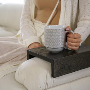 Sofa arm tray table made from solid white oak fits over the arm of your couch to create a convenient and sturdy surface for daily use perfect for holding snacks coffee remotes or a phone this wood couch side table adds function and style to compact living spaces with a clean natural finish
