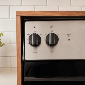 Above stove storage shelf with walnut wood finish designed to hold spice jars seasoning bottles oil containers and kitchen decor while keeping the countertop clean organized and easy to use in a modern or farmhouse kitchen