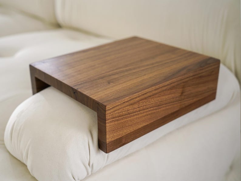 Wood couch side table in natural white oak designed as a sofa arm tray or armrest table perfect for compact spaces and modern living rooms this table fits securely on your couch arm providing a stable surface for coffee books remotes or snacks great for enhancing comfort and function in tight spaces